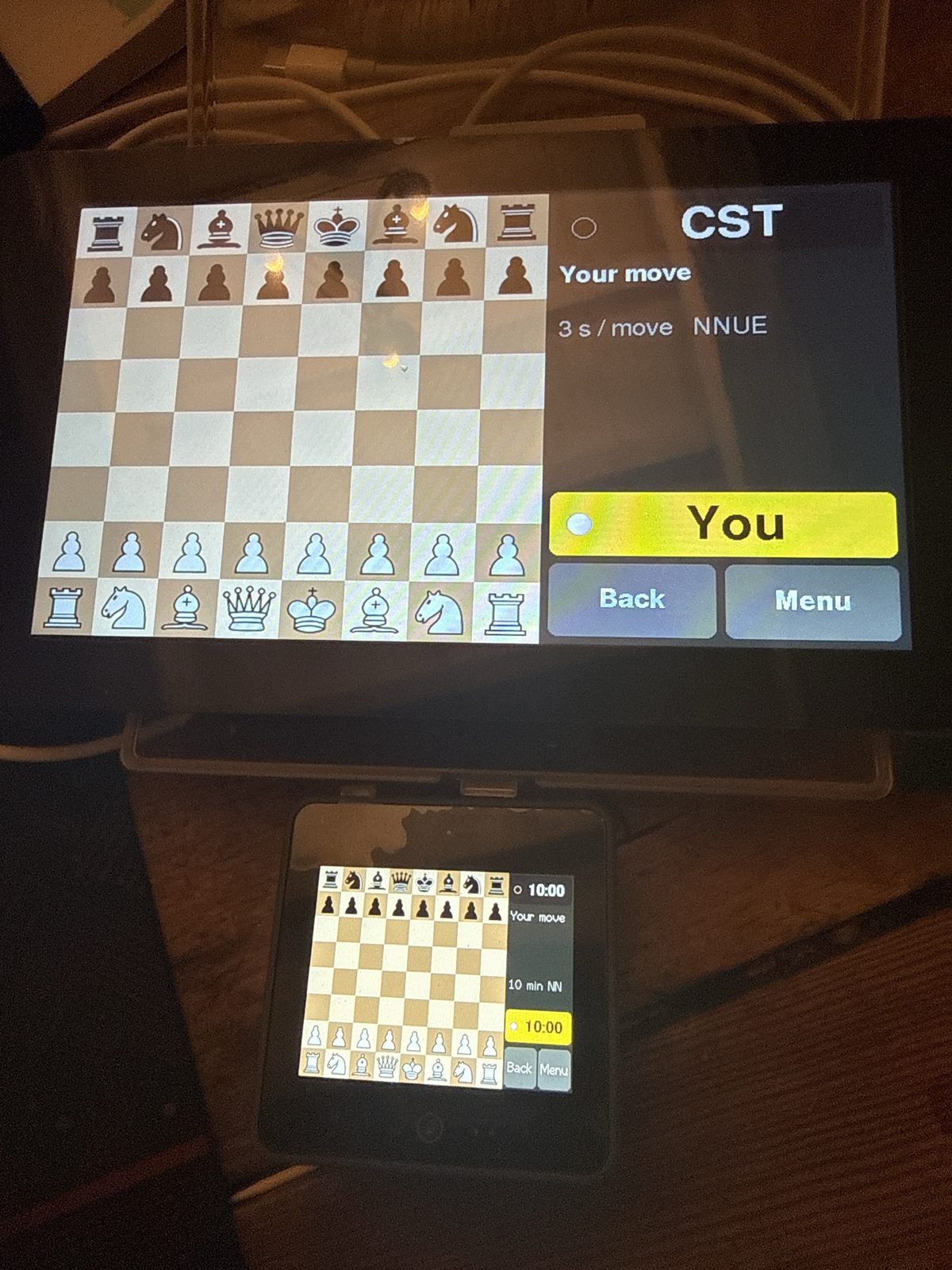 Chess System Tal Retro on two boards: the 7-inch Waveshare touch screen with the 2-inch M5Stack CoreS3 in front of it, both at the start of a game